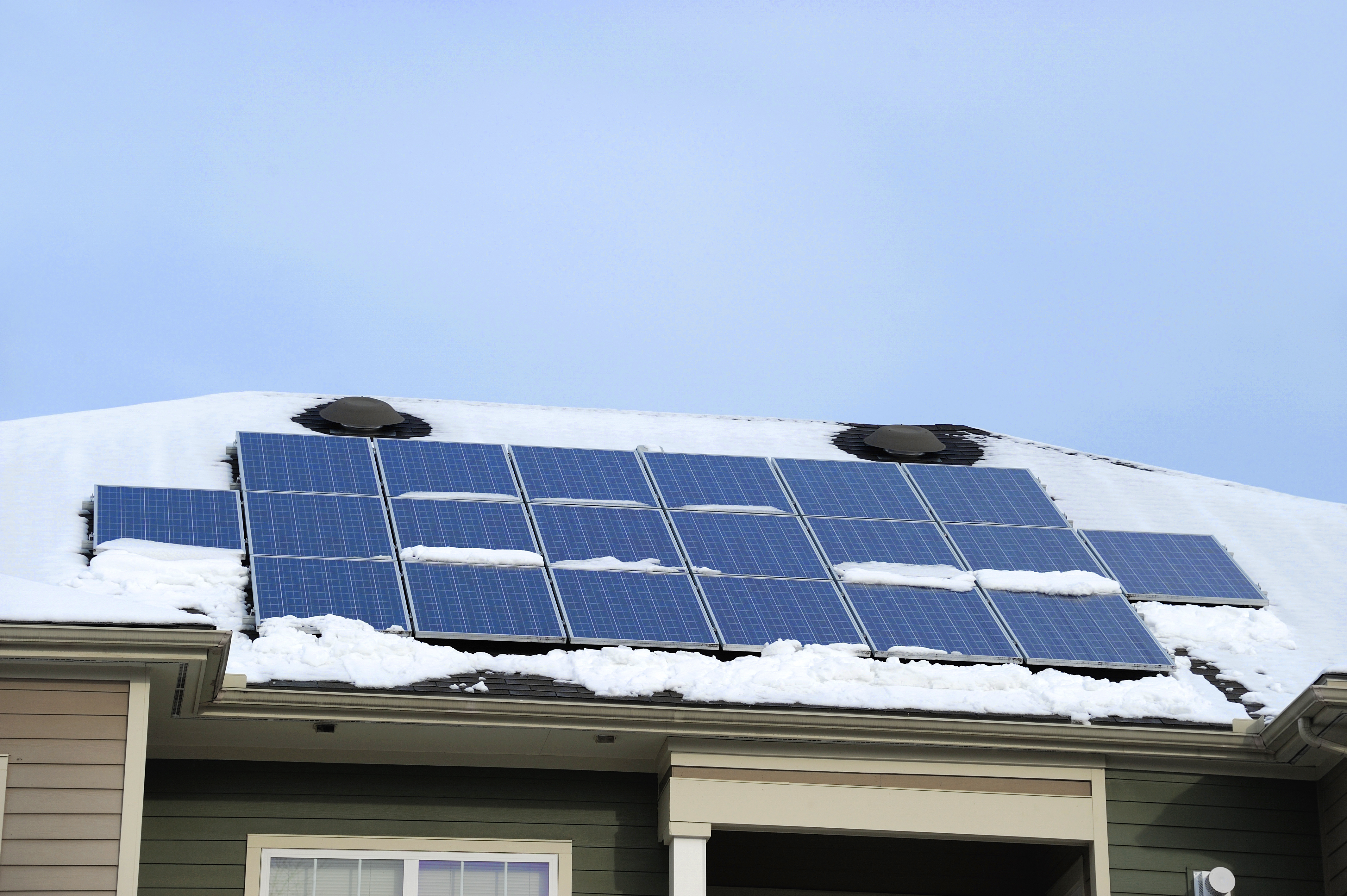 solar panel on the roof after snow in winter Sun Source Homes